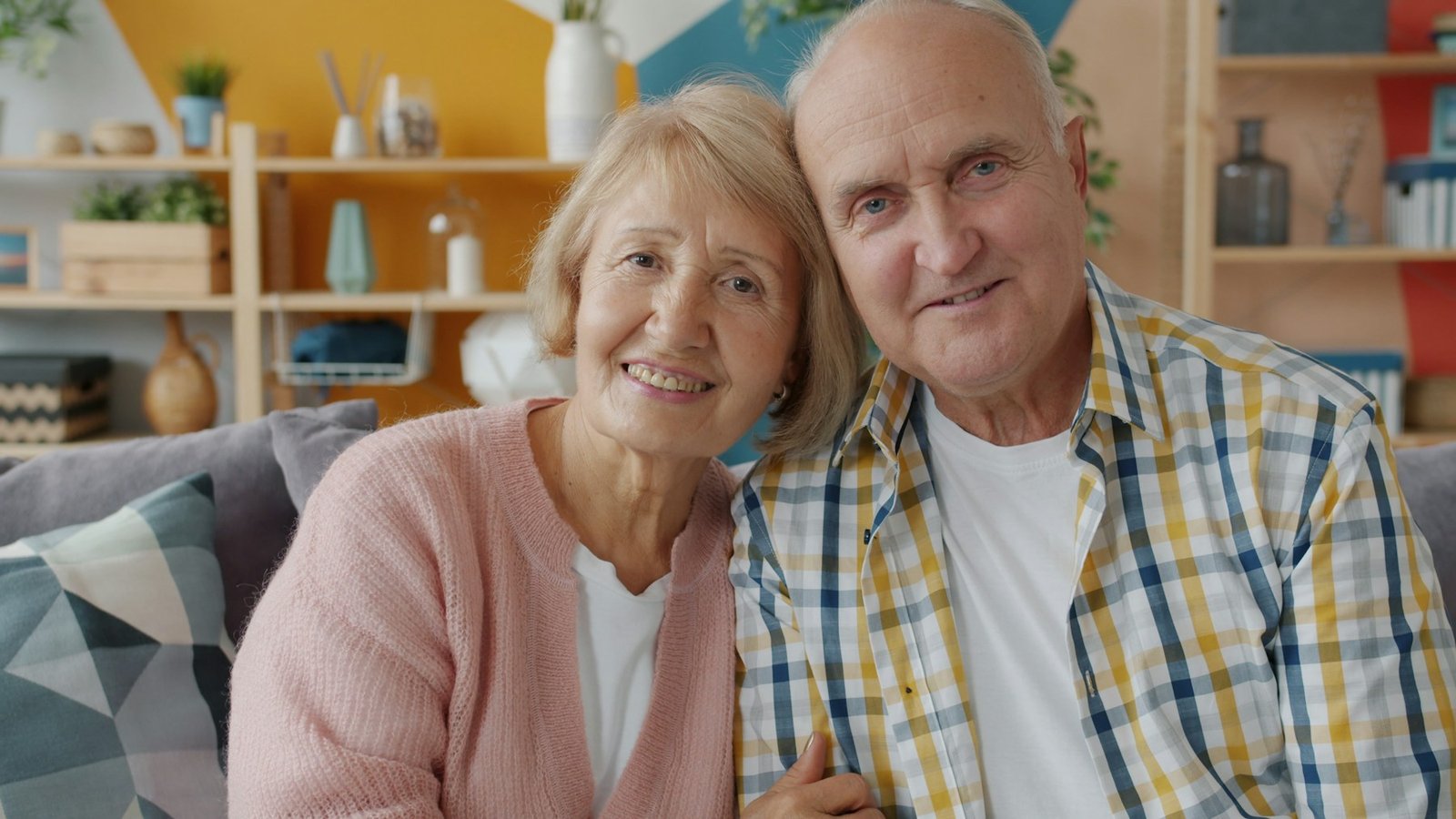 A smiling retired couple relaxing together at home
